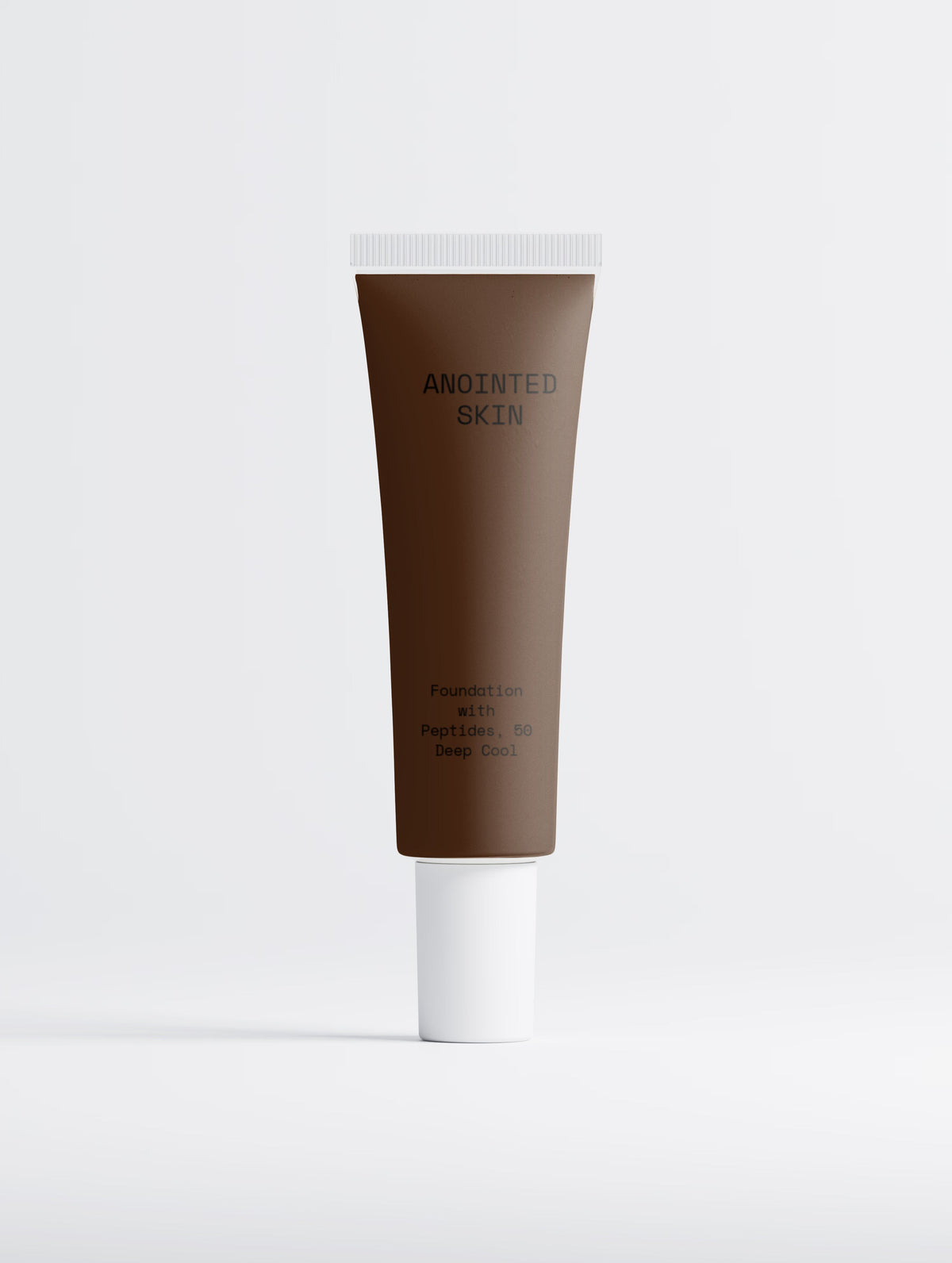 Anointed Garments Anointed Skin Peptide Foundation in 50 Deep Cool, a dark brown liquid foundation in a squeeze tube.