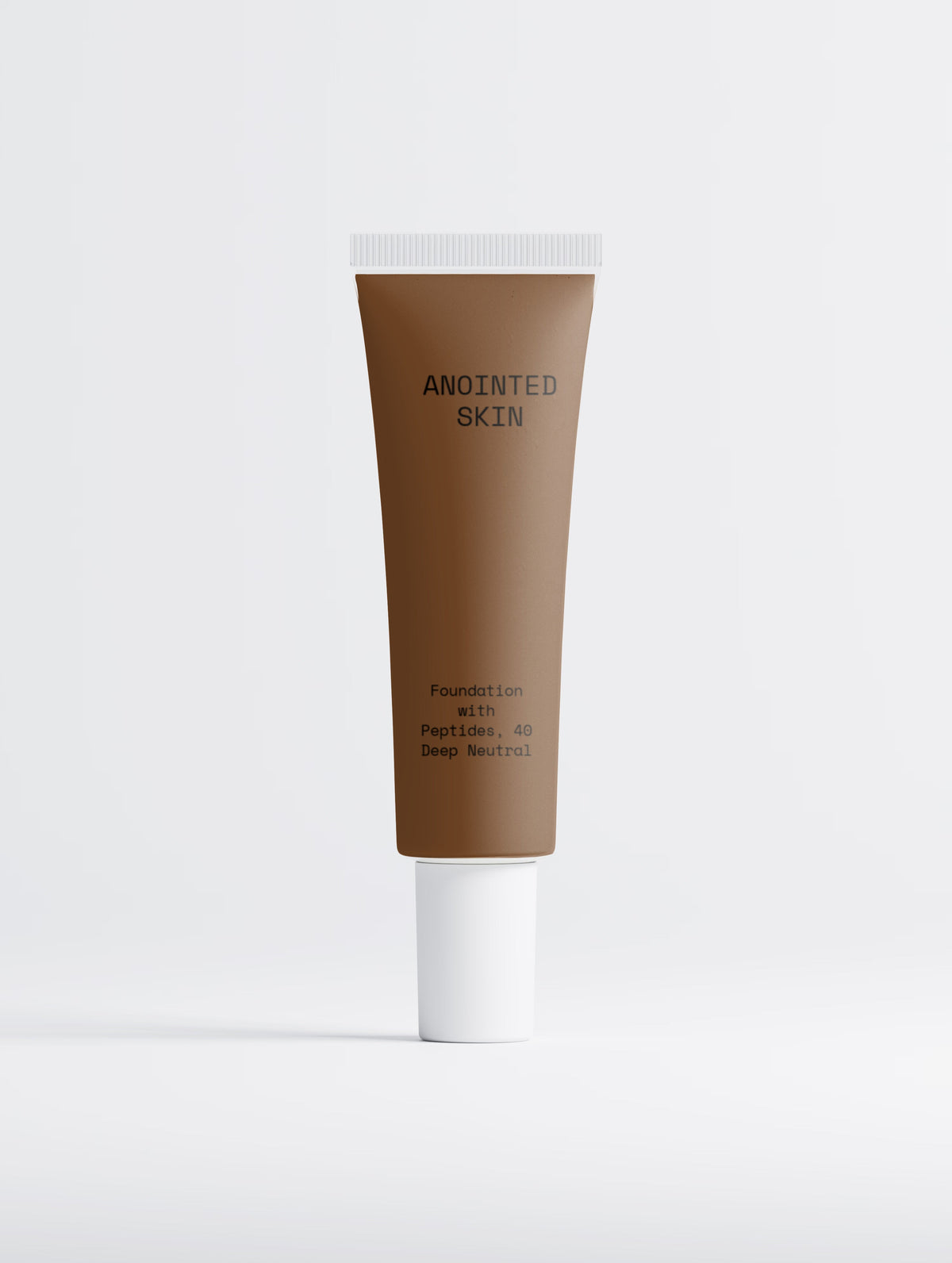 Anointed Garments Anointed Skin Peptide Foundation in 40 Deep Neutral, a deep brown liquid foundation in a squeeze tube.