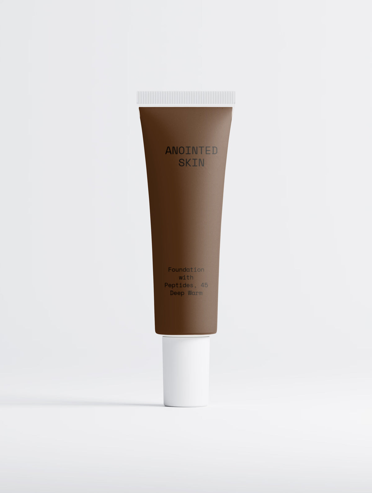 Anointed Skin® Peptide Foundation in 45 Deep Warm, a deep brown liquid foundation in a squeeze tube.