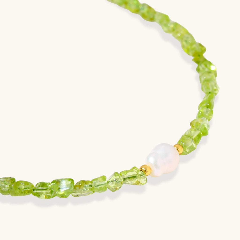 Anointed Garments Peridot Dreams bracelet featuring vibrant green peridot chips and a central freshwater pearl.