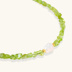 Anointed Garments Peridot Dreams bracelet featuring vibrant green peridot chips and a central freshwater pearl.