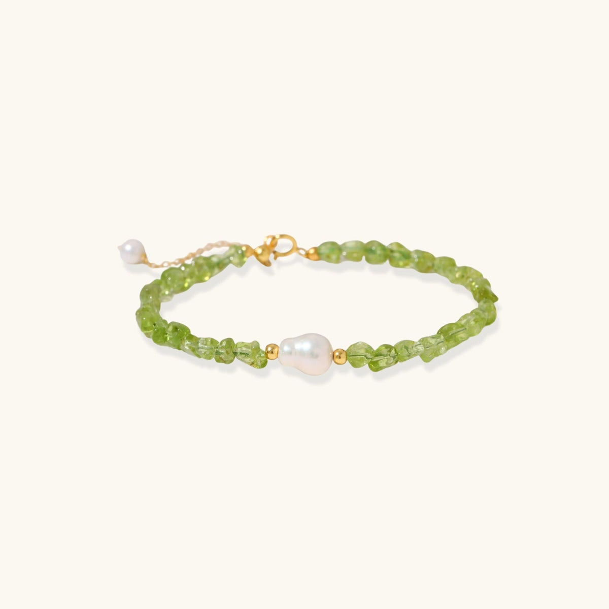 Anointed Garments Peridot Dreams bracelet featuring green peridot chips and a central freshwater pearl on silver.
