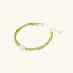 Anointed Garments Peridot Dreams bracelet featuring green peridot chip stones and a freshwater pearl on silver chain.