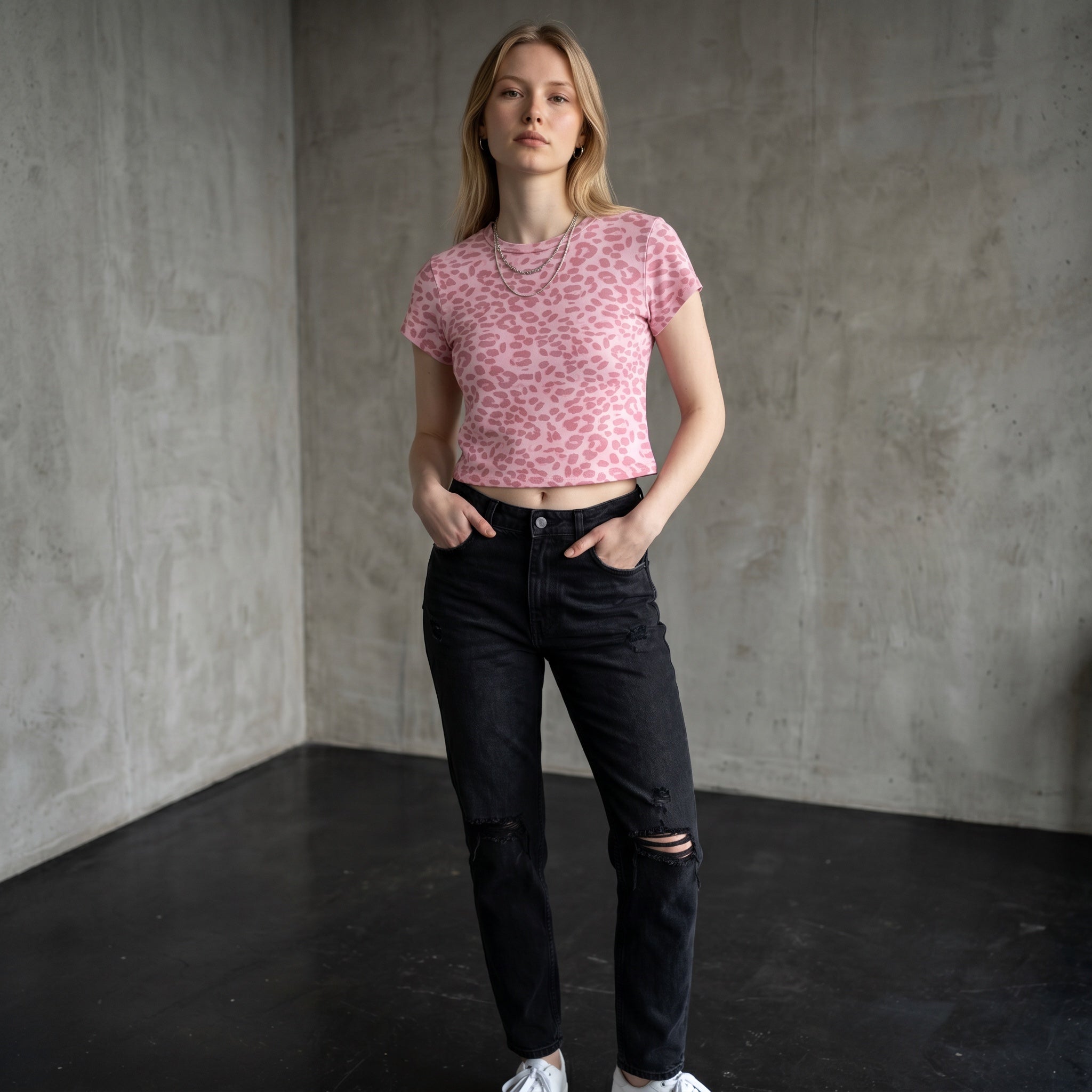 Anointed Garments pink animal print crop t-shirt with crew neck worn by a woman with black distressed jeans