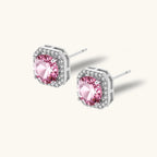 Anointed Garments blush halo moissanite stud earrings in platinum-plated 925 sterling silver with round pink stones.
