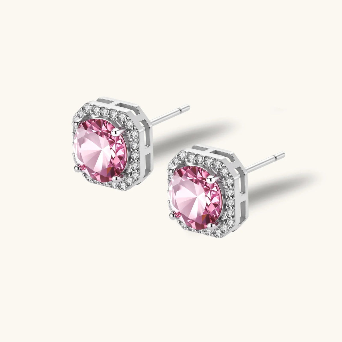 Anointed Garments blush halo moissanite stud earrings in platinum-plated 925 sterling silver with round pink stones.