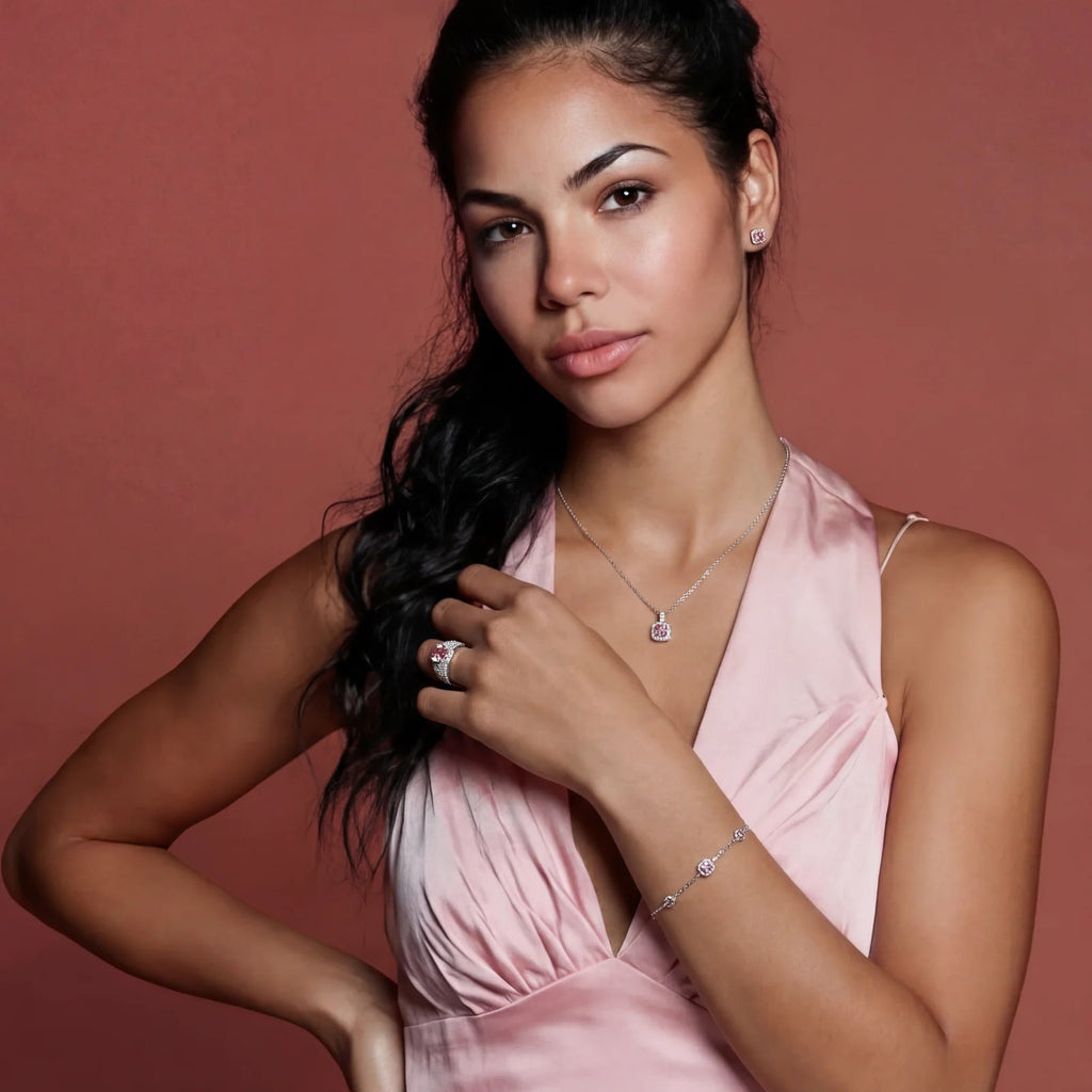 Model wearing Anointed Garments pink moissanite necklace, earrings, ring, and bracelet in platinum-plated silver.