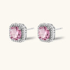 Anointed Garments blush halo moissanite stud earrings in platinum-plated 925 sterling silver with round pink stones.