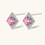 Anointed Garments pink round-cut moissanite stud earrings in platinum-plated sterling silver with geometric halo setting.