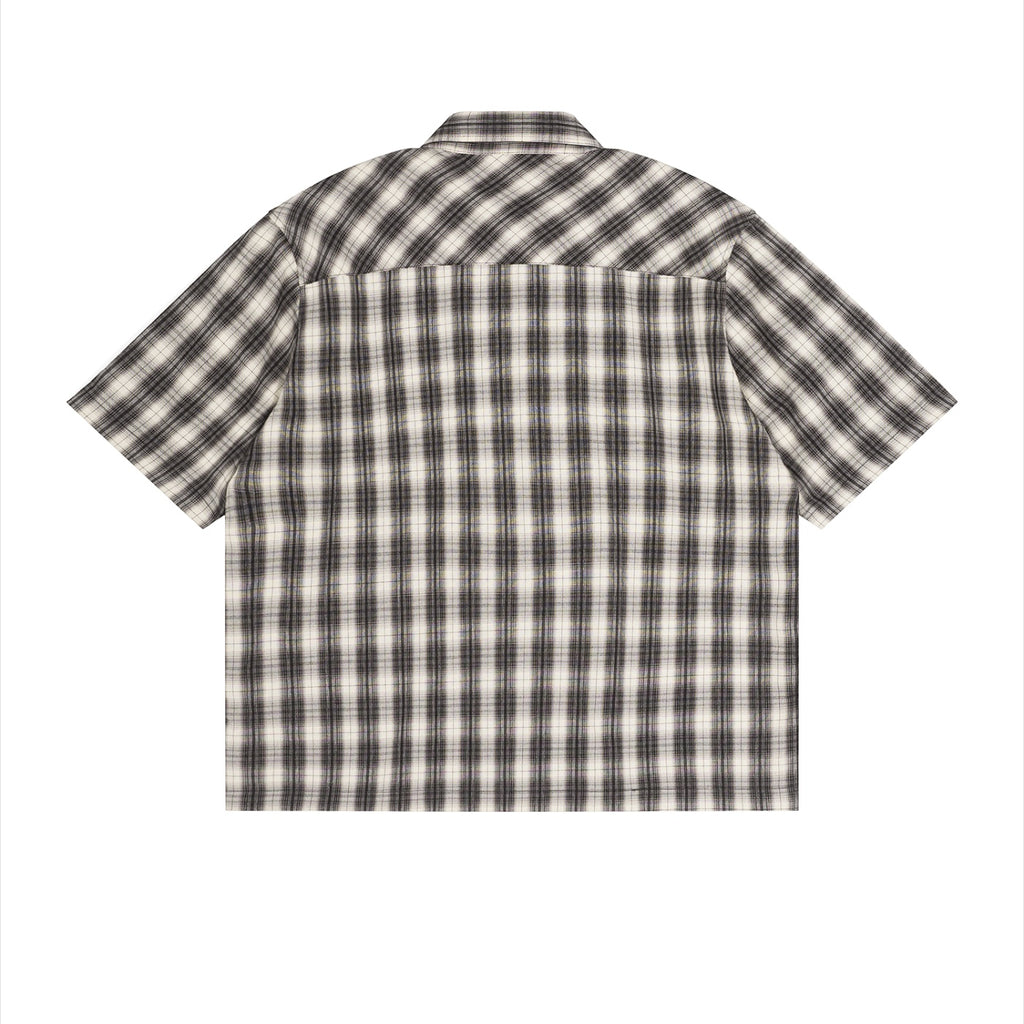 Back view of an Anointed Garments unisex short sleeve shirt in a black and white plaid pattern with a boxy fit.