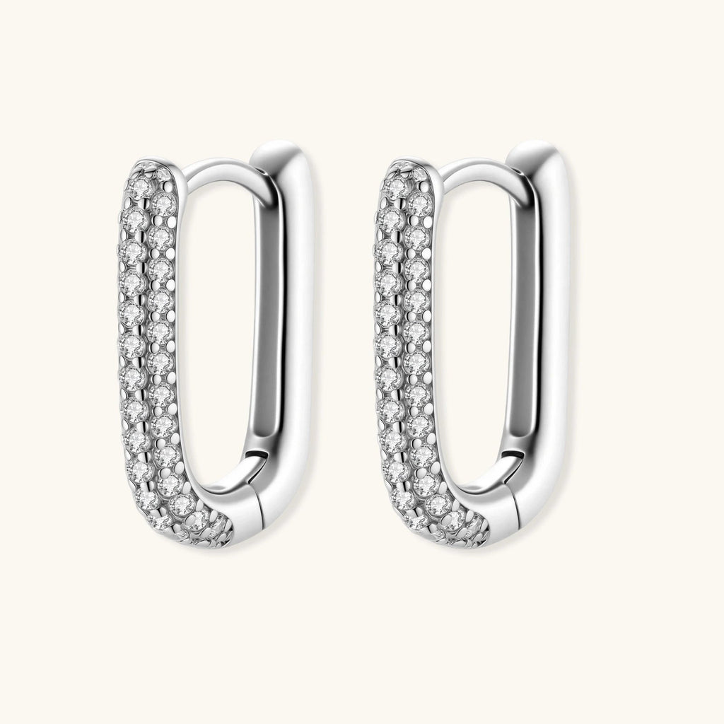 Anointed Garments platinum-plated sterling silver huggie hoop earrings with pavé-set crystals in a sleek oval shape.
