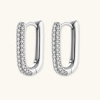 Anointed Garments platinum-plated sterling silver huggie hoop earrings with pavé-set crystals in a sleek oval shape.