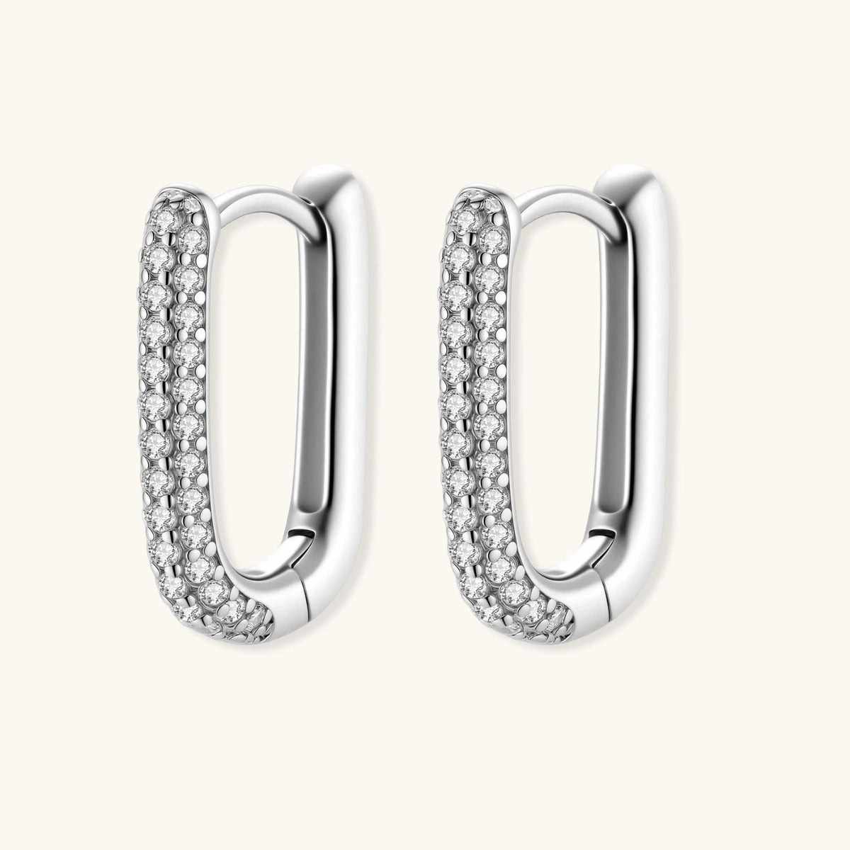 Anointed Garments platinum-plated sterling silver huggie hoop earrings with pavé-set crystals in a sleek oval shape.