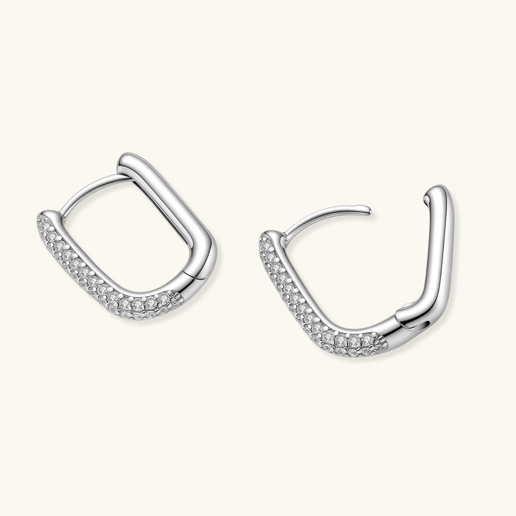 Anointed Garments platinum-plated 925 sterling silver huggie hoops with a polished finish and pavé crystal accents.
