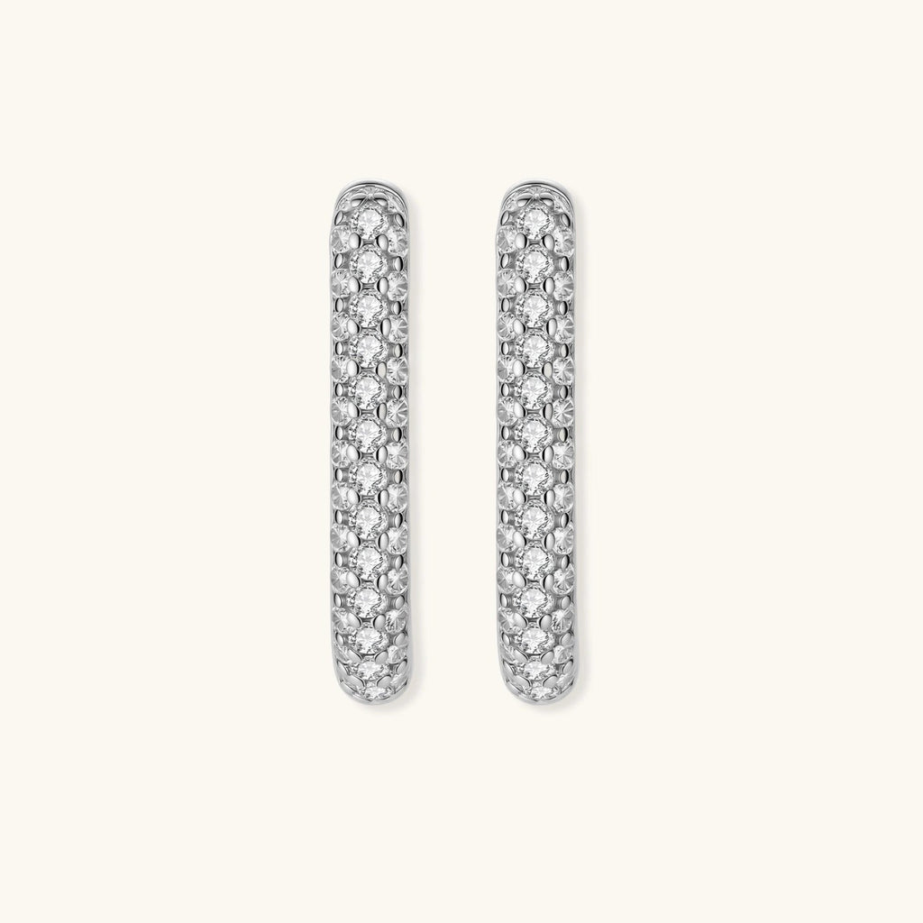 Anointed Garments platinum-plated sterling silver huggie hoops featuring a sleek, pavé-set crystal design.