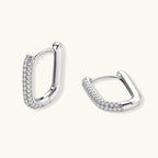 Anointed Garments platinum-plated sterling silver huggie hoops with pavé-set stones in a sleek rectangular design.