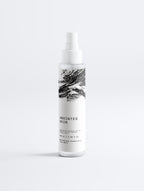 Anointed Garments Anointed Skin Prebiotic Hydrating Face Mist in a white spray bottle with black brushstroke design.