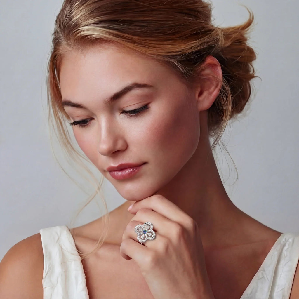 Anointed Garments Prismatic Bloom moissanite ring with a floral design on a woman wearing a white dress