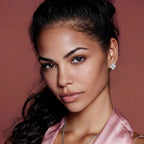 Anointed Garments quatrefoil moissanite stud earrings in platinum-plated sterling silver worn by a model.