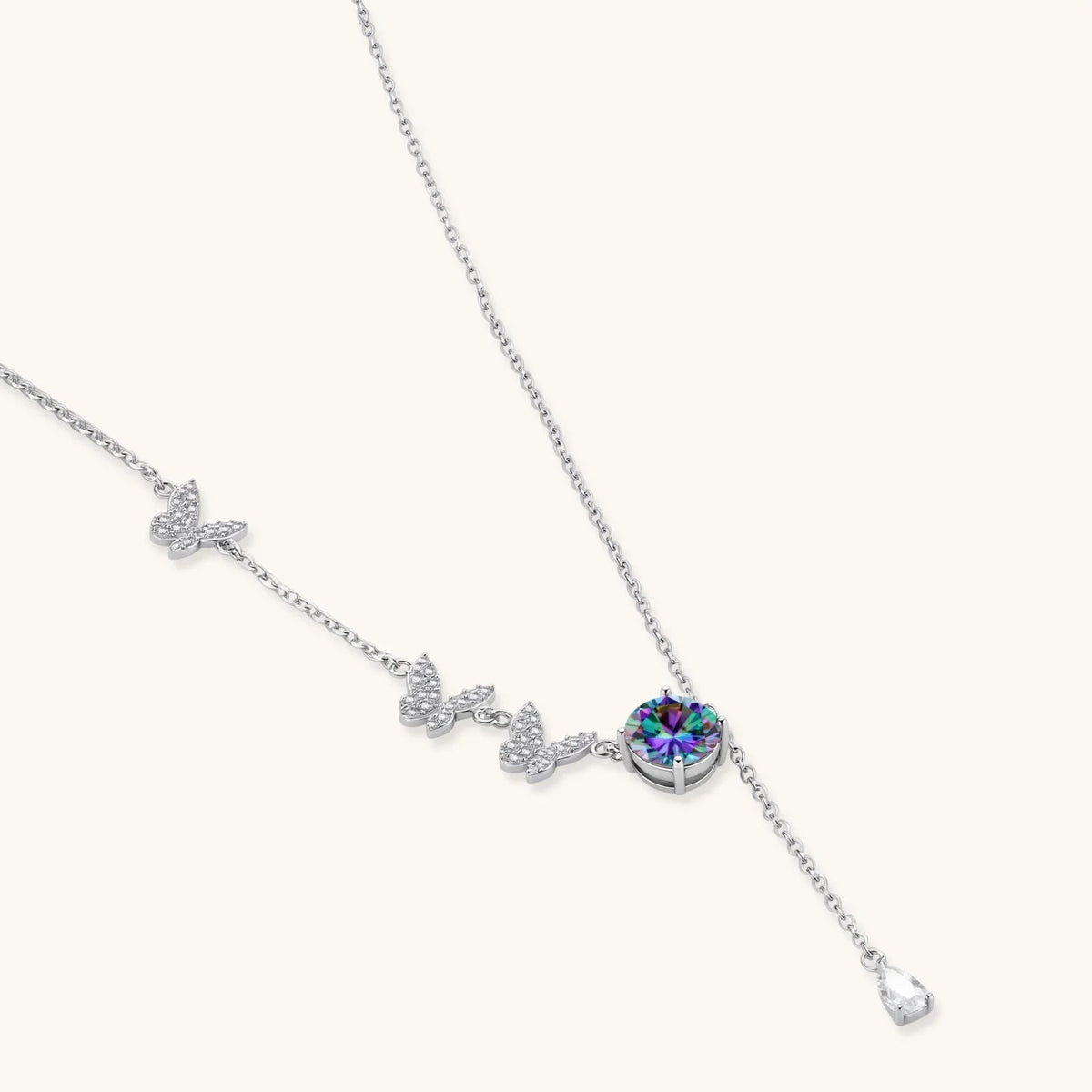 Anointed Garments rainbow moissanite necklace in platinum-plated 925 sterling silver with butterfly and teardrop charms.