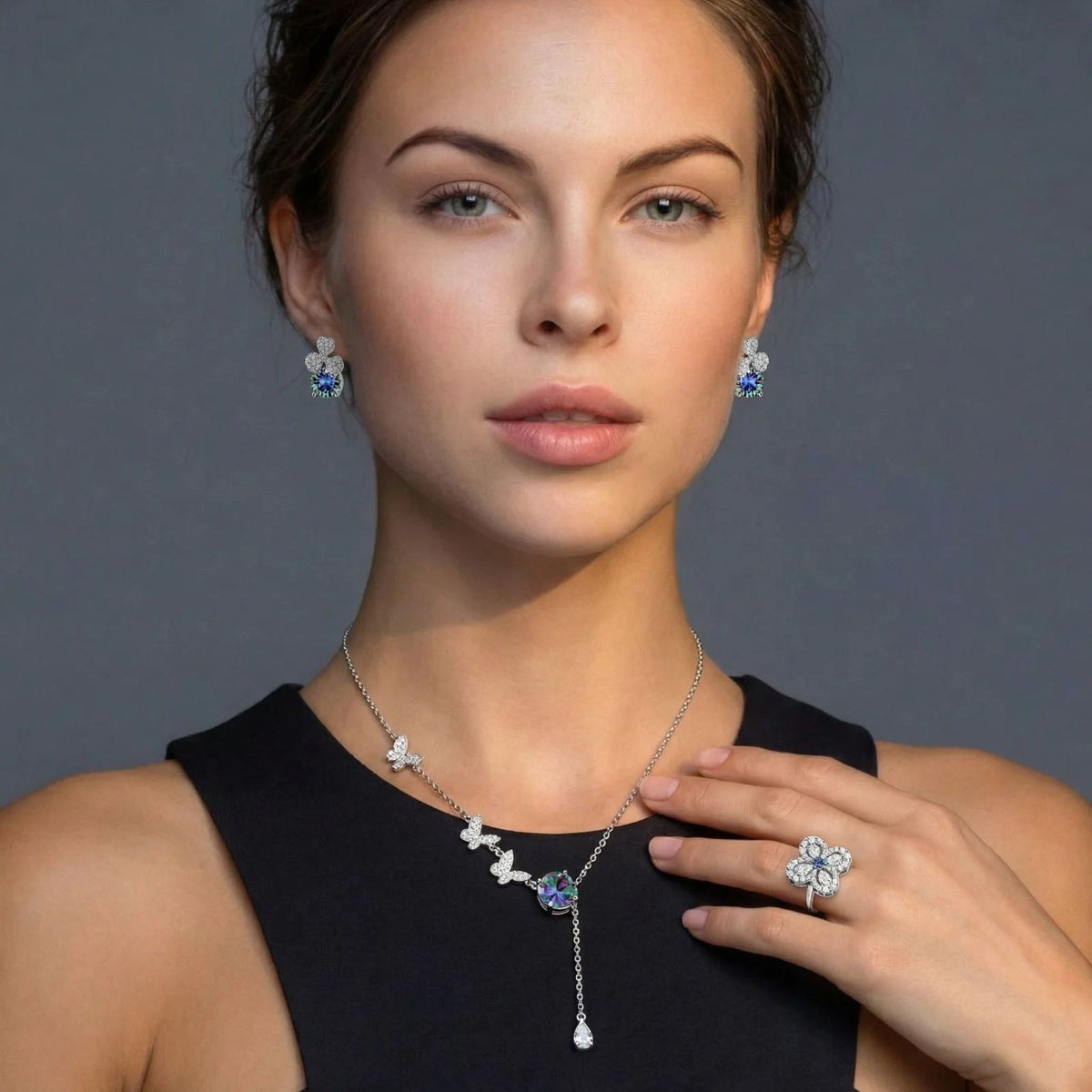 Anointed Garments rainbow moissanite jewelry set featuring a necklace, earrings, and ring in platinum-plated silver.