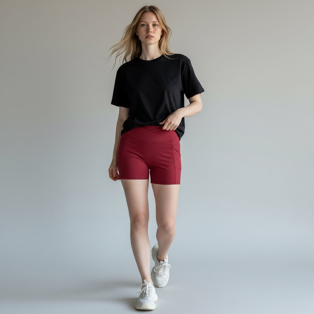 Anointed Garments high-waisted athletic shorts in deep red with side pockets, worn by a model in a black t-shirt.