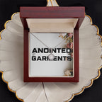 Anointed Garments round halo pendant necklace with cubic zirconia crystals in a wooden gift box on a decorative plate.