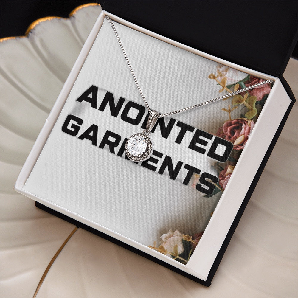 Anointed Garments round halo pendant necklace with cubic zirconia crystals on a silver-tone chain in a gift box.