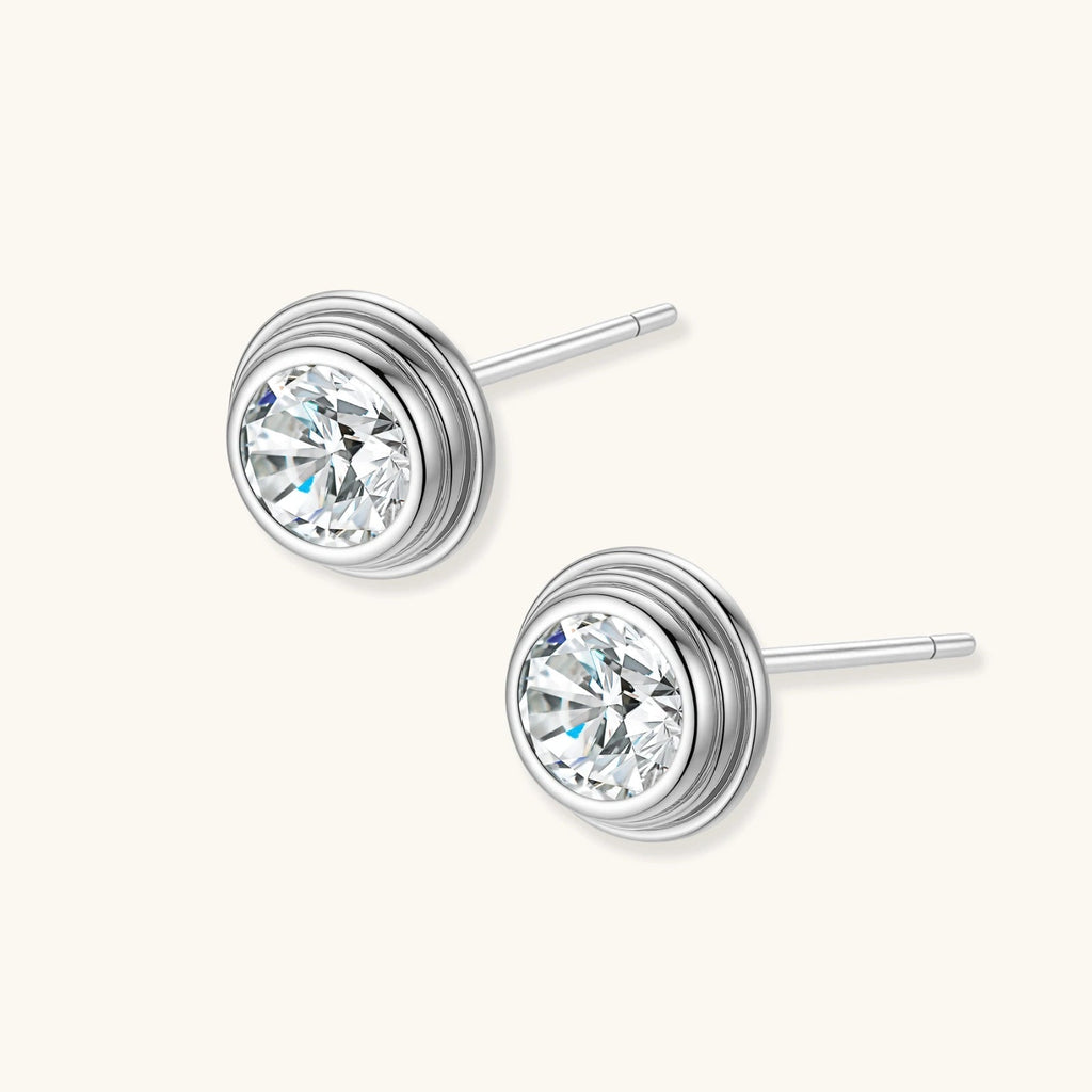 Anointed Garments round moissanite stud earrings in platinum-plated 925 sterling silver with concentric circle design.