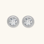 Anointed Garments round moissanite stud earrings in platinum-plated 925 sterling silver with concentric circle frames.