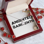 Anointed Garments round pendant necklace with a cubic zirconia center stone in a mahogany gift box with red berries.