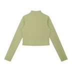 Back view of Anointed Garments sage green cropped long sleeve mock neck zip up jacket in high-stretch athletic fabric.