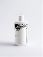 Anointed Garments Silk Repair Hair Conditioner in a white bottle with black text and abstract graphic design.