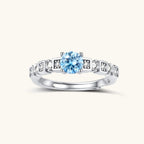 Anointed Garments Skyline Moissanite Ring featuring a round light blue stone in a platinum-plated sterling silver band.
