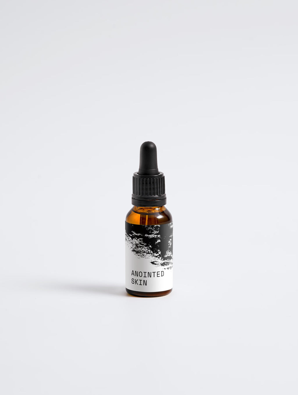 Anointed Garments Anointed Skin Softening Beard Oil in an amber glass dropper bottle with a black label.