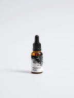 Anointed Garments Anointed Skin Softening Beard Oil in an amber glass dropper bottle with a black label.