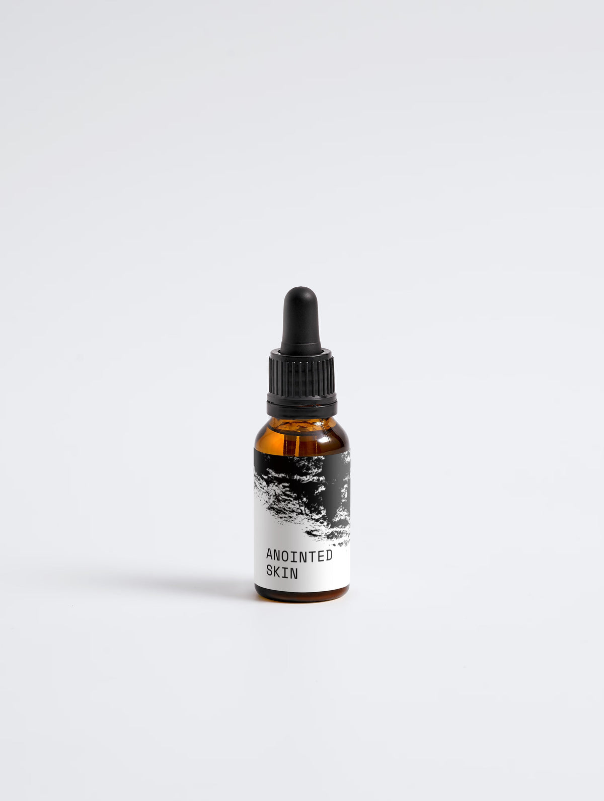 Anointed Garments Anointed Skin Softening Beard Oil in an amber glass dropper bottle with a black label.