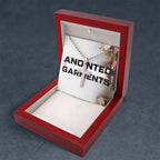 Anointed Garments stainless steel classic cross pendant necklace on a ball chain inside a polished wooden gift box.