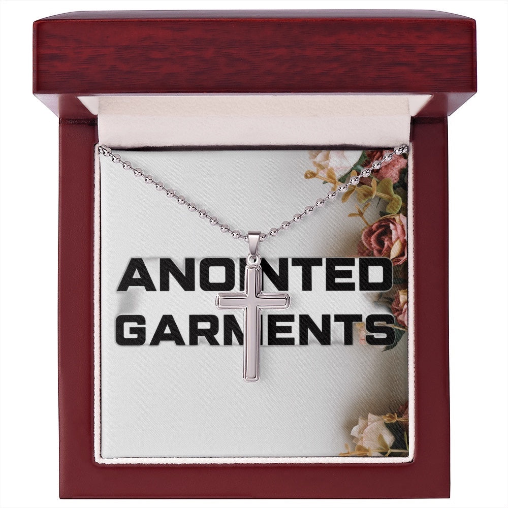 Anointed Garments stainless steel cross pendant on a ball chain inside a polished wooden gift box.