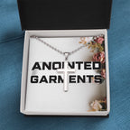 Anointed Garments stainless steel cross pendant on a ball chain inside an elegant branded gift box