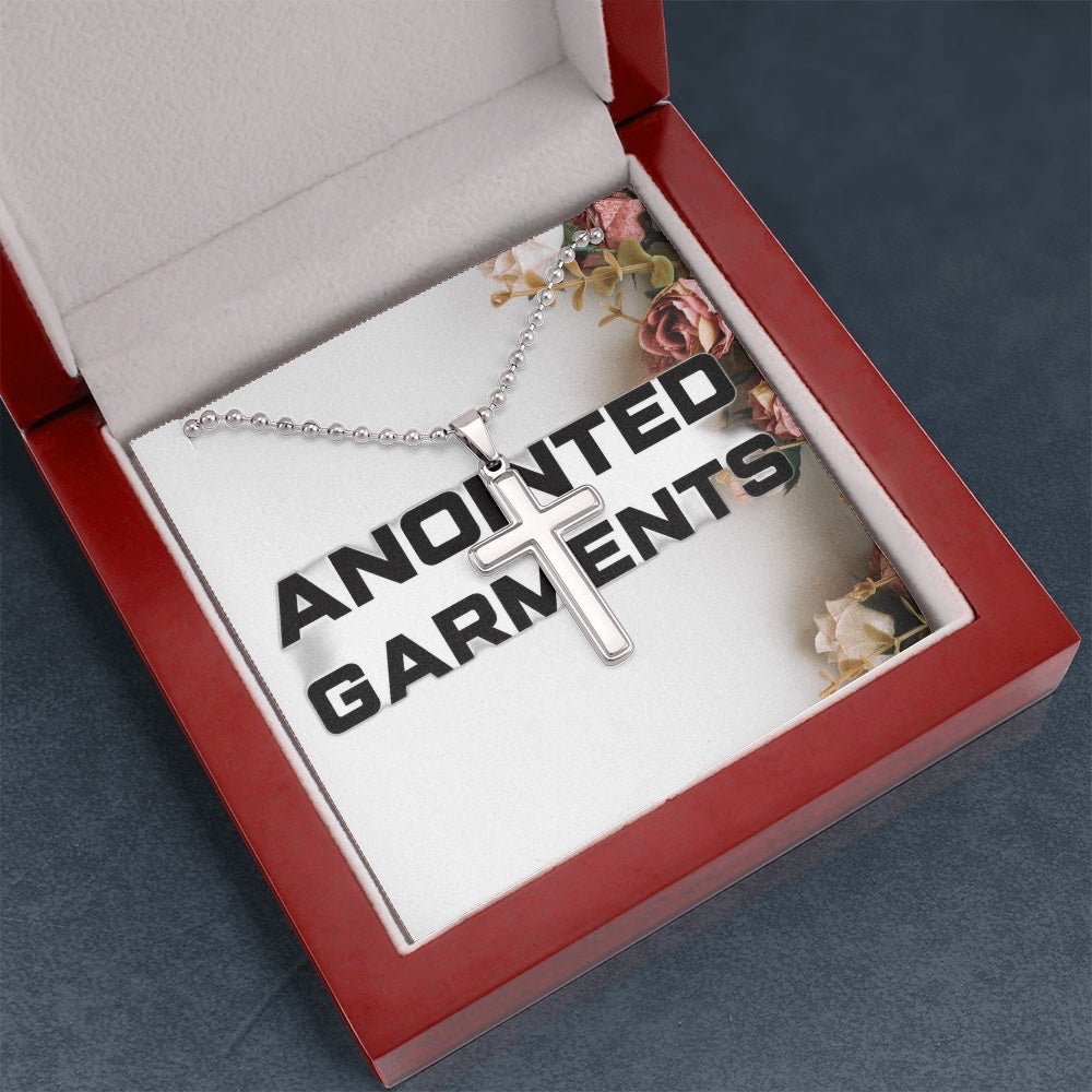 Anointed Garments stainless steel cross pendant necklace on a ball chain inside a red velvet presentation gift box.