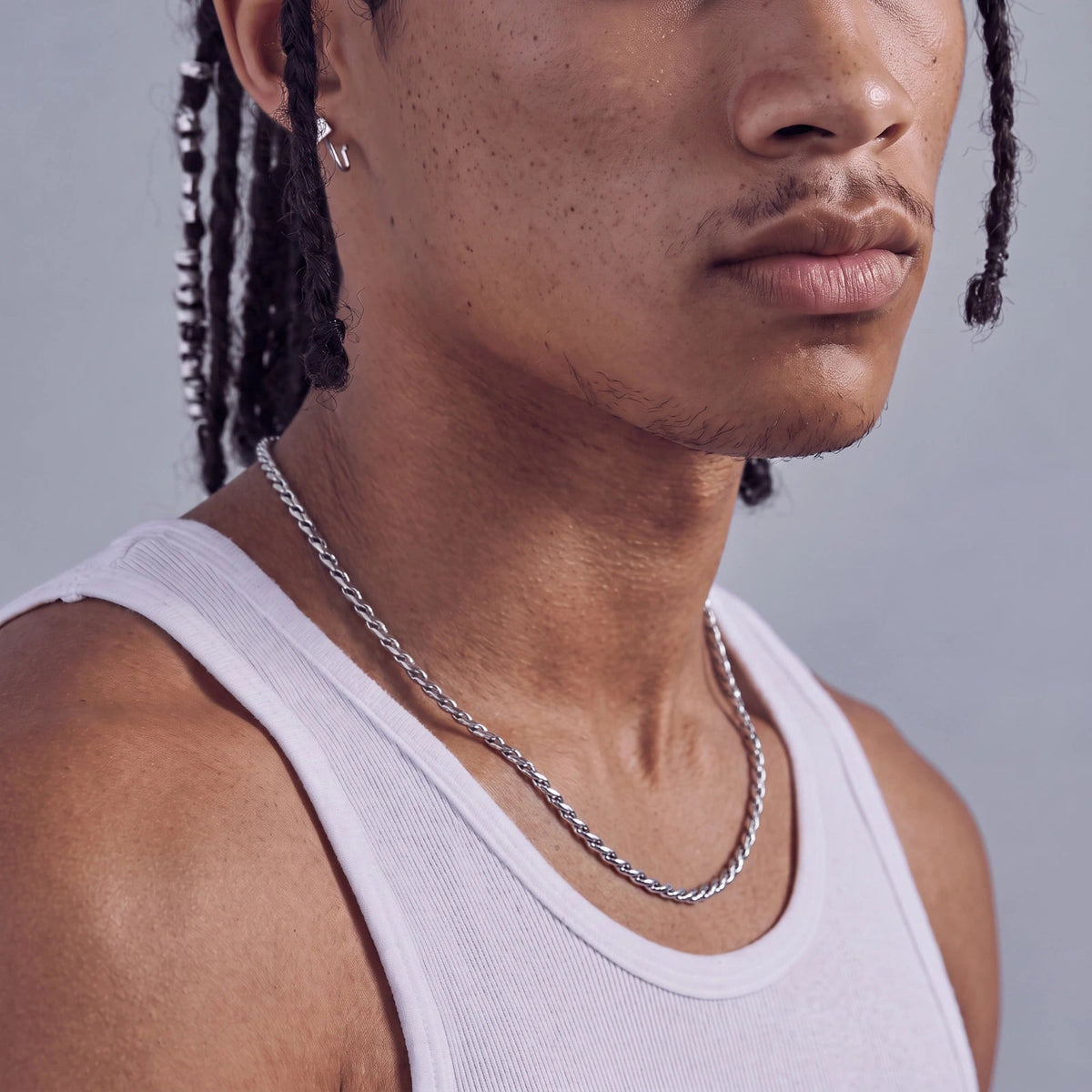 Anointed Garments polished stainless steel twisted rope chain worn by a man in a white tank top