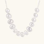 Anointed Garments Lunar Pearl Arc Necklace featuring graduated polished sterling silver circular forms on a chain.