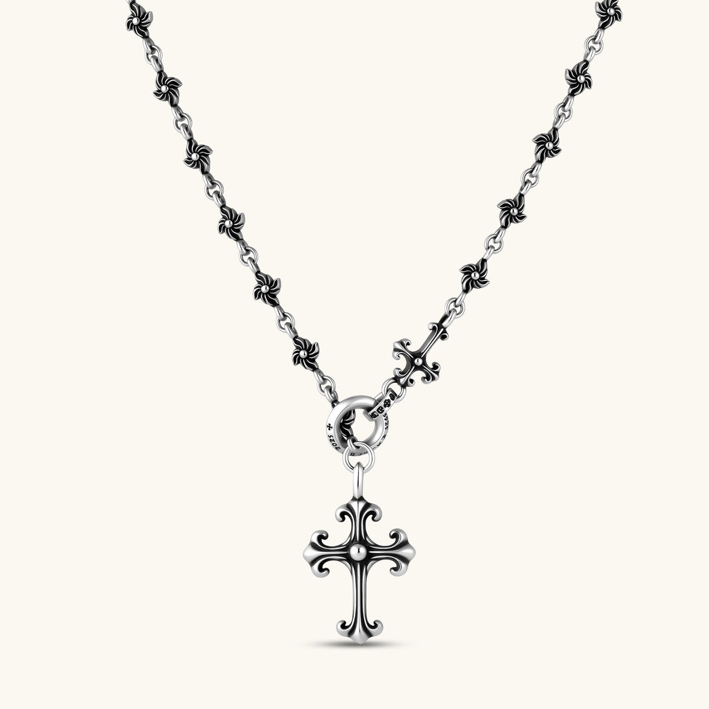 Anointed Garments sterling silver gothic cross necklace with an ornate fleur-de-lis pendant and floral chain links.