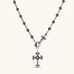 Anointed Garments sterling silver gothic cross necklace with an ornate fleur-de-lis pendant and floral chain links.