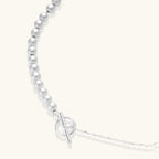 Anointed Garments sterling silver necklace with graduated polished spheres and a toggle clasp on a light background.