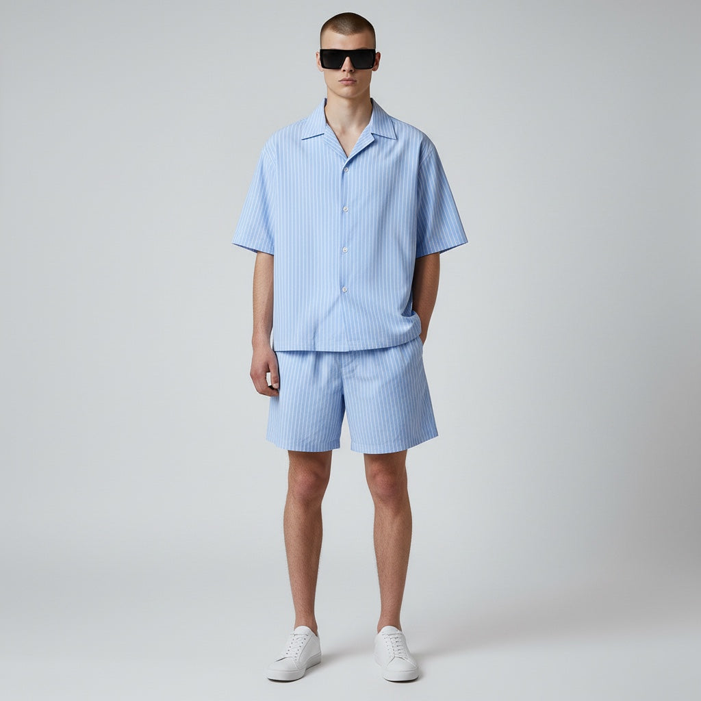 Anointed Garments model wearing a light blue and white striped button-down shirt and matching elastic waist shorts.