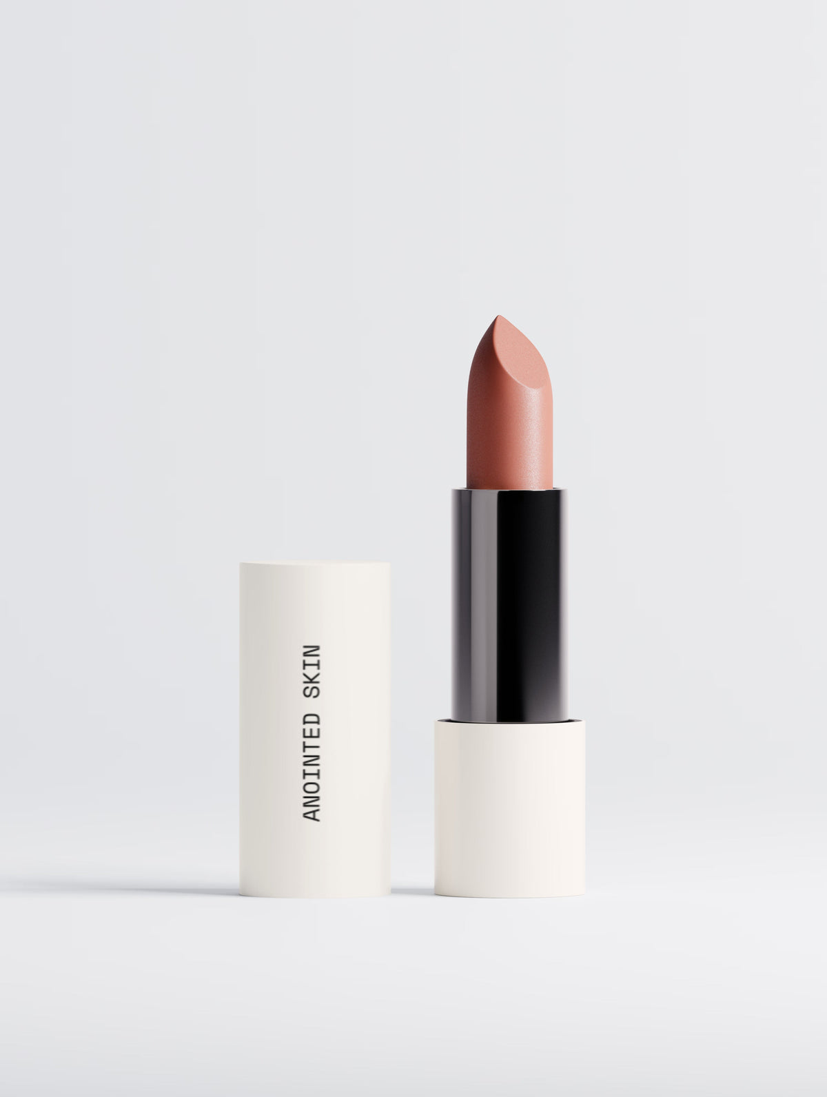 Anointed Garments Anointed Skin matte lipstick in Terracotta Nude with a creamy, velvety satin finish in a white tube.