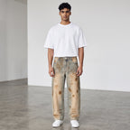 Model wearing Anointed Garments relaxed barrel-leg denim jeans with a vintage wash and distressed sun-faded details.