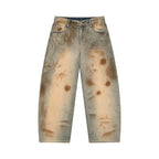 Anointed Garments men's relaxed barrel-leg denim jeans in a vintage wash with distressed sun-faded brown accents.